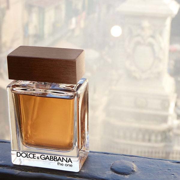Dolce Gabbana The One for men fragrance bottle with city backdrop