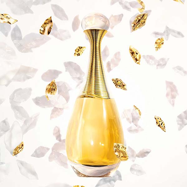 Dior J'Adore perfume bottle with ingredients surrounding 